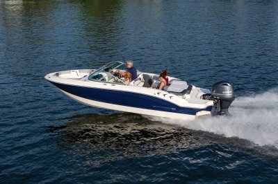 Chaparral 19 SSi OB cruising on a lake with four passengers rear port view. 