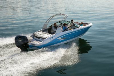 Chaparral 21 SSi OB cruising on a lake with four passengers rear starboard view 