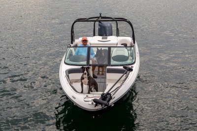 Chaparral 21 SSi OB Ski & Fish one passenger and dog at the helm and one dog on the casting deck. 