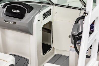 Chaparral 23 SSi OB locking glovebox and storage compartment built into the port console. 