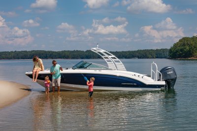 Chaparral 23 SSi OB with a family enjoying a sandbar at a lake. 