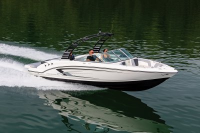 Chaparral 23 SSi cruising on lake with 3 passengers front starboard view. 