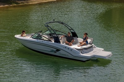 Chaparral 23 SSi one passenger on sun pad with three passengers in rear of boat. 