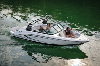 Chaparral 23 SSi on water with two people in bow two people in cockpit 