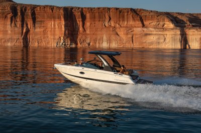 Chaparral GTS 6 running in lake with orange rock wall in background. 