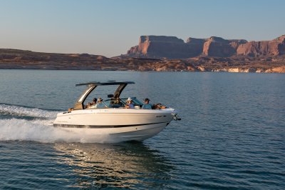 Chaparral GTS 6 running in lake with 5 passengers and mountains in distance 