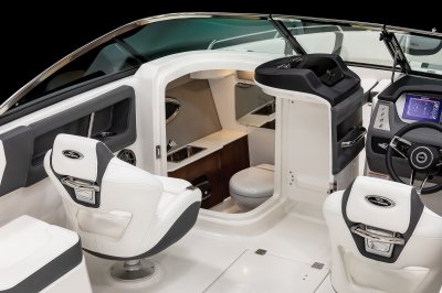 Chaparral 250 OSX head door opens toward center and reveals toilet, sink, and portlight. 