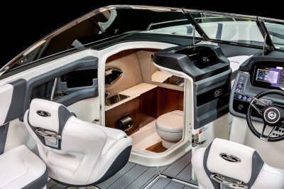 Chaparral 270 OSX head compartment with sink, portlight, and toilet. 