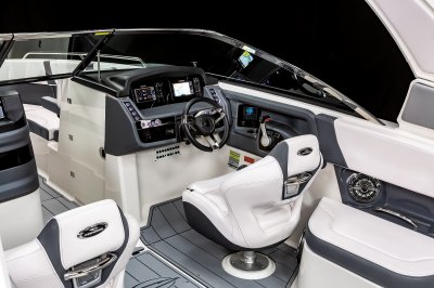 Chaparral 270 OSX helm station with captain's chair and tilting steering wheel. 