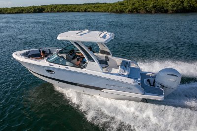 Chaparral 270 OSX running on water with a person in the bow and one at the helm 