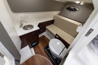 Chaparral 280 OSX head toilet mounted on a track that hides away when not in use. 