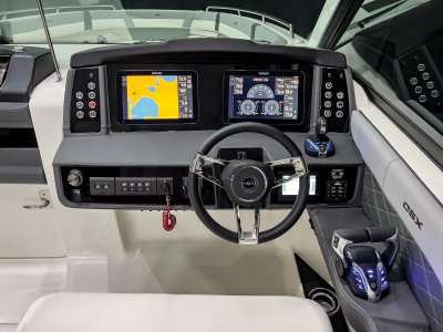 Chaparral 310 OSX helm with twin Simrad NSX12 displays, tilt steering wheel, and metal switches. 