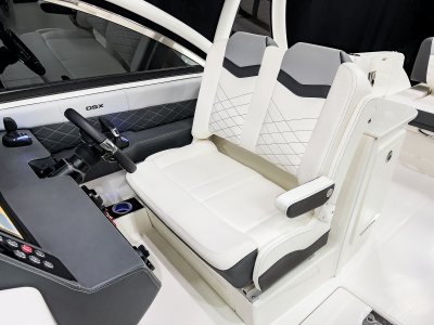 Chaparral 310 OSX double helm chair with flip-up bolster and a folding armrest. 