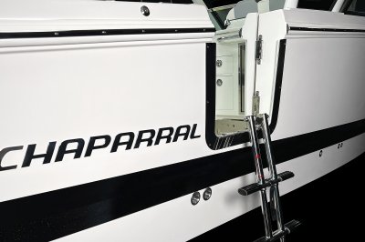 Chaparral 310 OSX side-entry door with polished metal hardware and magnetic latch. 