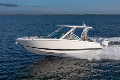 Chaparral 310 OSX cruising on the ocean with 4 passengers 
