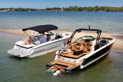 Chaparral 247 SSX on a lake parked next another 247 SSX with kids swimming. 