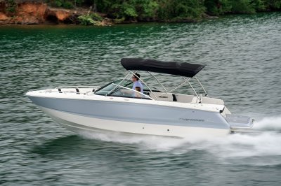 Chaparral 247 SSX with a bimini top cruising on a lake port view. 
