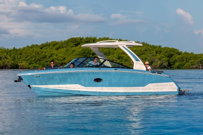 Chaparral SSX 30 4 people idling in the ocean with trees in the background 