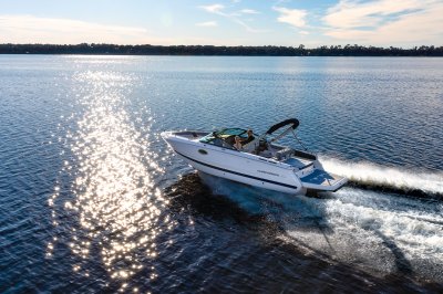 Chaparral SSX 4 running in the ocean with a tree line in the background 