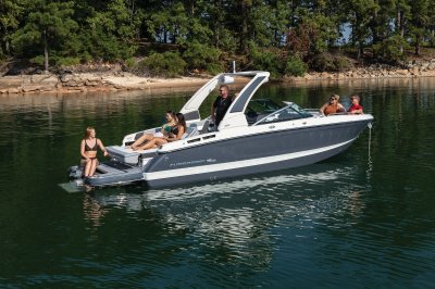 Chaparral 267 SSX anchored in a cove with people lounging and swimming. 