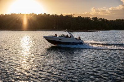 Chaparral SSX 6 cruising at sunset on a lake with 2 people in the bow and 2 people in the cockpit 