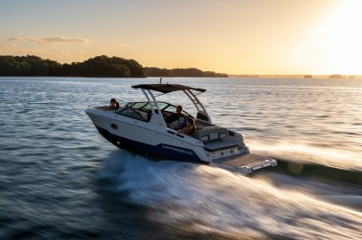 Chaparral SSX 6 running on a lake at sunset with 1 person riding in the bow and 2 in the cockpit 