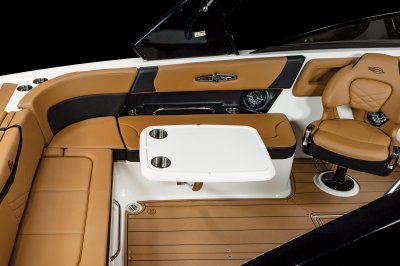 Chaparral 28 SURF table mounted on the port side with two cupholders and metal hardware. 