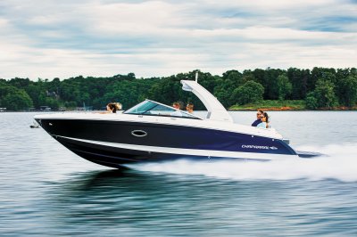 Chaparral 30 SURF cruising in front of a shoreline, showing the port profile of the boat 